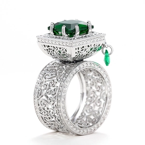 Detailed view of silver镂空 ring with square green gemstone and drop pendant charm