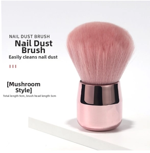 Detail of rose gold nail dust brush with pink fiber bristles measuring 9cm in length