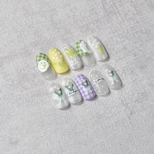 Macro detail of 3D embossed lily of the valley nail stickers with elegant bow accents