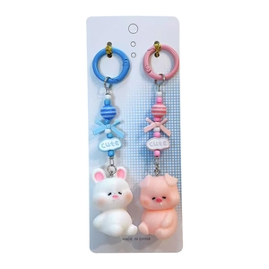 Cute pig and rabbit charms on keychains with blue and pink accents