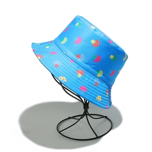 Detail of blue sun hat with colorful mushroom print and water-resistant fabric texture