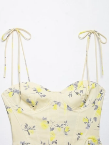 Close-up of floral print camisole featuring tie-up straps and corset-style bust seam details