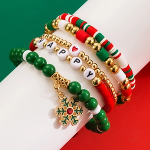 Macro shot of Christmas bracelet set with snowflake charm and red green clay beads