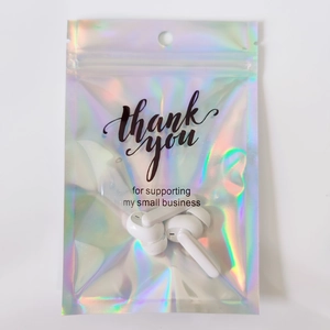 Macro view of holographic zip lock bag with thank you text for wireless earbuds