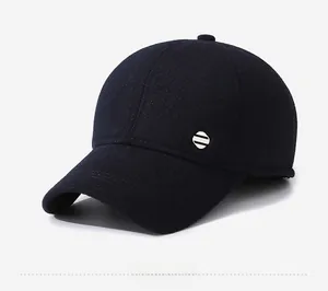 Detailed side view of thick navy blue wool baseball cap with decorative metal side element