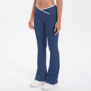 Detail of high waist flared yoga pants featuring unique white V-shaped cross waistband design