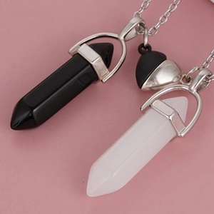 Detail of magnetic heart clasp connecting black and white hexagonal stone necklaces
