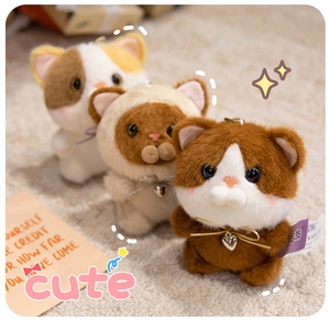 Detailed view of three cute plush cat keychains with bowties and metal heart charms