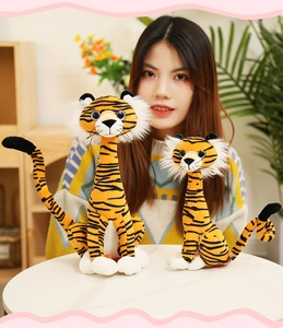 Two realistic plush tiger toys in large and small sizes on a white table