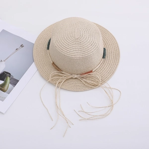 Detailed top view of beige straw sun hat with bohemian tassel bow and colored cord