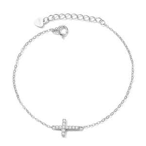 Detail of S925 sterling silver cross bracelet featuring clear gems and a heart-shaped tag