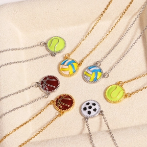 Detailed view of colorful enamel sports ball pendants on gold and silver necklaces