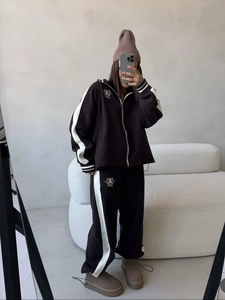 Women's black casual tracksuit with white side stripes and half-zip collar design