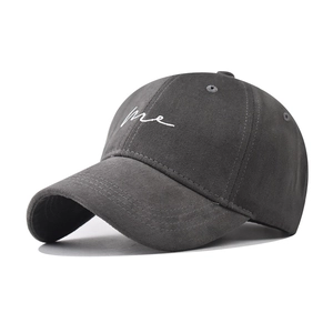 Close-up of me letter embroidery on dark grey cotton twill baseball cap fabric