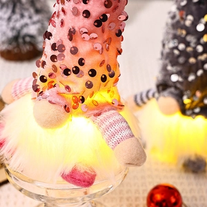 Detail of pink sequin Christmas gnome featuring LED light and soft plush beard decoration