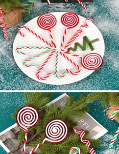 Macro detail of red, white, and green candy ornaments arranged on festive pine branches