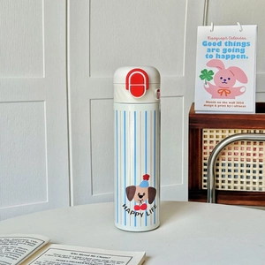 Detail view of a white insulated mug with blue stripes and cute cartoon dog illustration