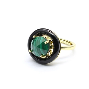 Detail view of round faceted malachite and black onyx stones set in a gold metal ring band