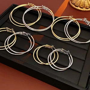 Detailed set of gold and silver hoop earrings in various sizes on jewelry display