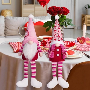 Detail of couple Valentine's Day long-legged gnomes with heart patterns for home decor