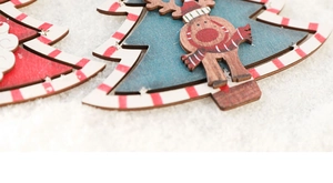 Detail of multi-layered painted wooden Santa ornament with vintage Nordic texture