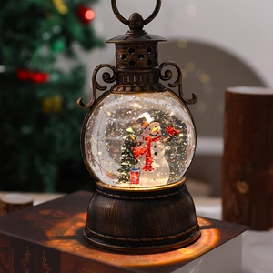 Detail of vintage bronze lantern with snowman scene and swirling snow inside