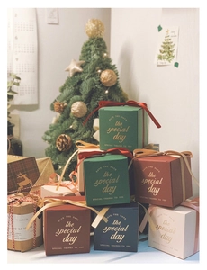 Christmas gift boxes in velvet colors with satin ribbons and gold foil lettering