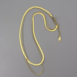 Detail of double-layer gold snake bone and bead necklace showing 18KGP engraving