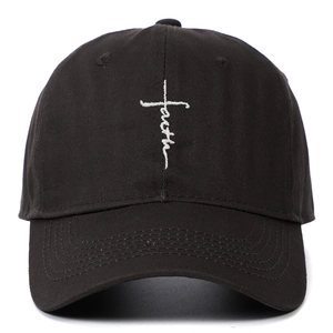 Close-up of white faith and cross embroidery on black cotton canvas baseball cap