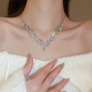 Detailed view of silver-toned fringe necklace with sparkling waterdrop gemstones