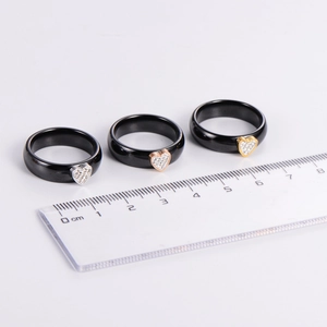 Three-piece black ceramic ring set with heart-shaped crystals in gold and silver finishes