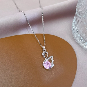 Detail of a swan pendant necklace with pink crystal and small cubic zirconia stones