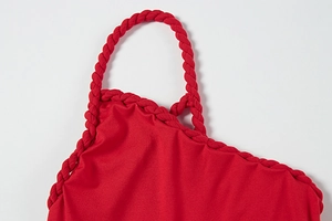 Detail of red sexy dress featuring handcrafted woven shoulder straps and texture