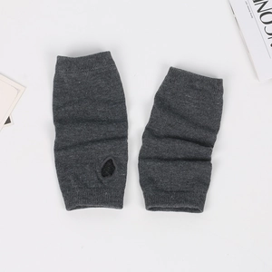 Close-up of dark grey knitted fingerless gloves with thumb hole on a white background