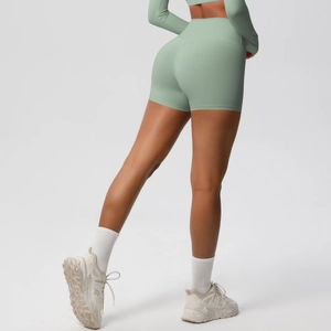 Rear view of high-waisted pale green yoga shorts showing lifting effect and soft fabric