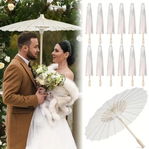 Detail of 12 white paper umbrellas with bamboo ribs for wedding and photography decor