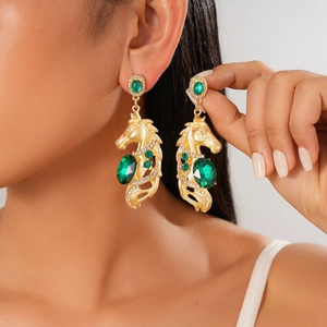 Detail of horse head earrings with green crystal and sparkling rhinestones on model