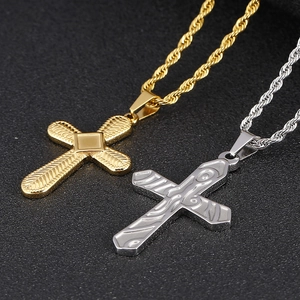 Macro shot of gold and silver stainless steel cross pendants with twisted rope chains