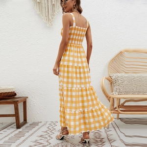 Detail of bohemian yellow gingham maxi dress showing layered tiered skirt and cinched waist