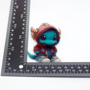 Detailed size measurement of the blue Christmas dragon acrylic pendant with ruler guide