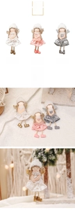 Close-up of plush Christmas angel ornaments with lace wings and sequin details