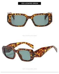 Detailed close-up of leopard pattern sunglasses with green lenses and bold square frames