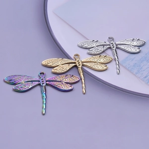 Detailed close-up of 18k plated dragonfly pendants in silver, gold and rainbow colors
