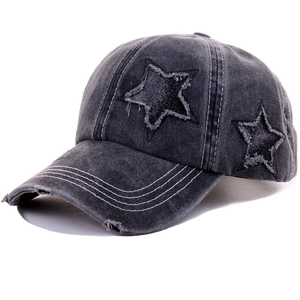 Detailed macro view of charcoal grey baseball cap with distressed star patches and stitching
