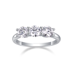 Macro view of silver three-stone ring with round brilliant cut moissanite accents
