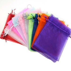 Colorful organza drawstring gift bags displayed in a vibrant fan-shaped arrangement