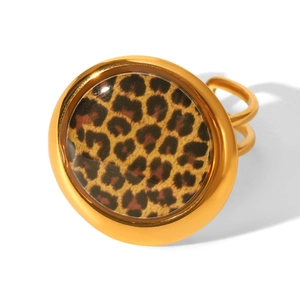 Detail of a golden leopard print open ring with a clear resin dome on a white background