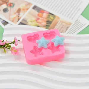 Pink silicone DIY mold for heart and star shapes with finished blue resin stars