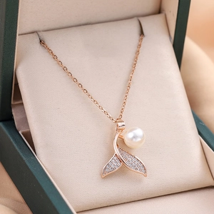 Elegant fishtail pearl pendant necklace in rose gold finish inside a green jewelry box