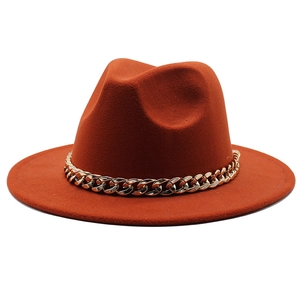 Detail of rust red felt jazz hat featuring a thick gold chain link band decoration